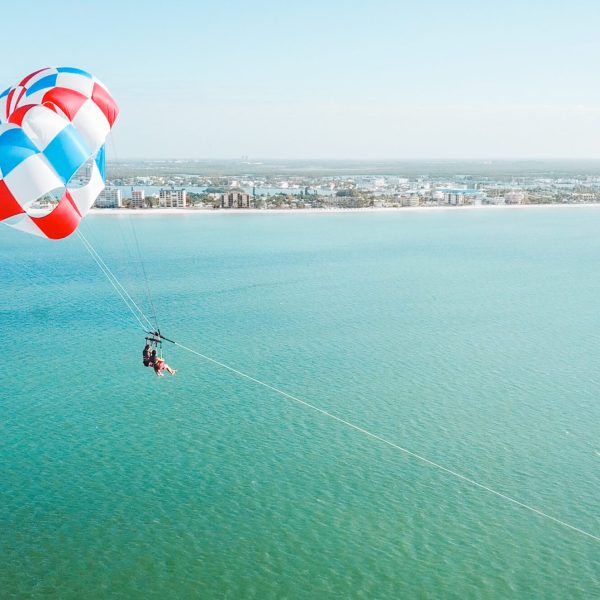a parachute is flying over a body of water
