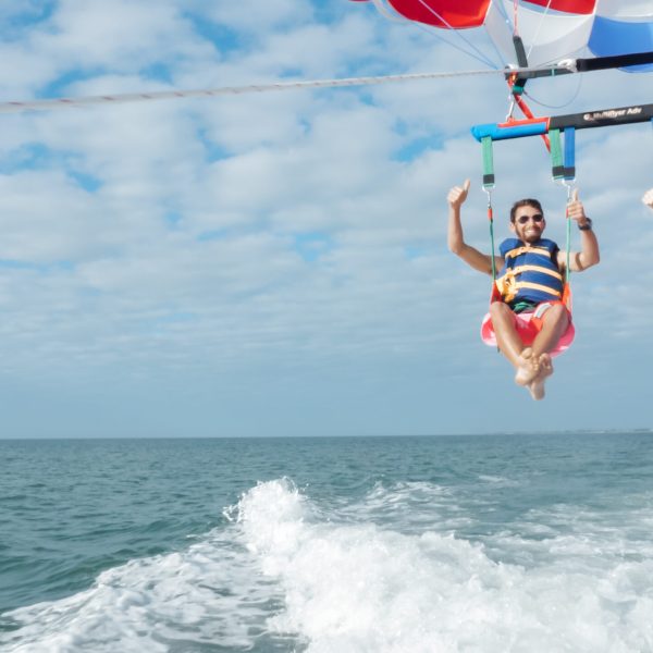 a man flying through the air while riding a wave in the ocean