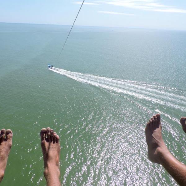 a man flying through the air over a body of water
